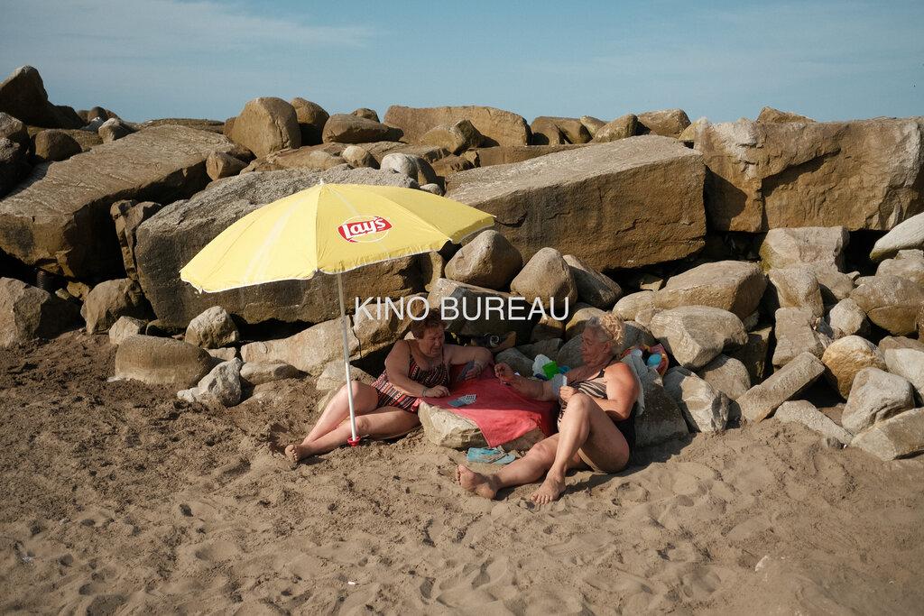 Women Playing Cards at the Beach
